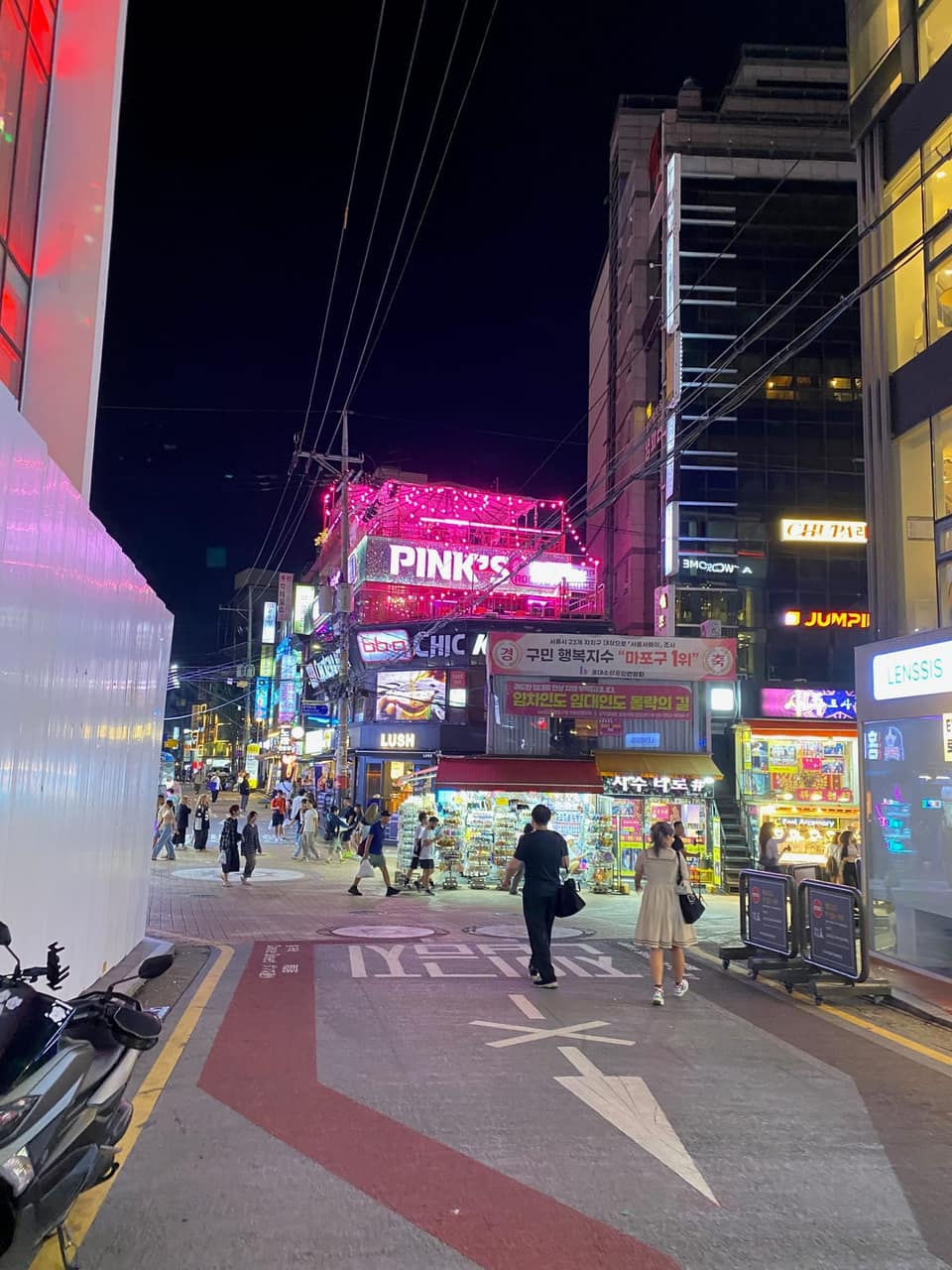 Neon-lit Hongdae street corner at night